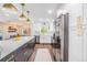 Open kitchen with a large island, stainless steel appliances, and view to the dining and living areas at 3120 S Polk Ave, Lakeland, FL 33803