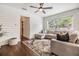 Cozy living room featuring shiplap accent wall, large window, and stylish area rug at 3120 S Polk Ave, Lakeland, FL 33803