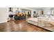 Spacious open-concept living room featuring a modern kitchen, comfortable seating, and hardwood floors at 3120 S Polk Ave, Lakeland, FL 33803