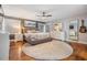 Spacious main bedroom featuring hardwood floors, a tufted headboard, and white dressers at 3120 S Polk Ave, Lakeland, FL 33803