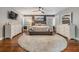 Large main bedroom with wood floors, gray walls, bright bay window and a round rug at 3120 S Polk Ave, Lakeland, FL 33803