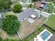 Aerial view of the home showcasing its backyard patio, fenced yard, and private pool at 4102 Stonehenge Rd, Mulberry, FL 33860