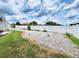 View of the backyard with a newly installed fence, and plenty of gravel for easy maintenance at 4102 Stonehenge Rd, Mulberry, FL 33860