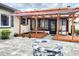 A covered patio featuring a swing, a lounge chair, and a firepit enhance this home's outdoor living space at 4102 Stonehenge Rd, Mulberry, FL 33860
