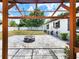 Inviting backyard featuring a brick-paved patio with a fire pit, perfect for outdoor entertaining at 4102 Stonehenge Rd, Mulberry, FL 33860