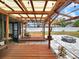 Inviting backyard patio with a pergola, string lights, outdoor seating, and a charming fire pit area at 4102 Stonehenge Rd, Mulberry, FL 33860