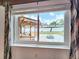 Window view of a backyard featuring a deck with outdoor seating and a firepit at 4102 Stonehenge Rd, Mulberry, FL 33860