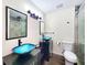 This bathroom has dual vessel sinks, dark wood cabinets, and a glass-enclosed shower at 4102 Stonehenge Rd, Mulberry, FL 33860