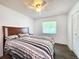 Bedroom with a bed, wooden headboard, a window and double closet at 4102 Stonehenge Rd, Mulberry, FL 33860