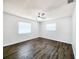 Bright bedroom featuring wood floors and two windows at 4102 Stonehenge Rd, Mulberry, FL 33860