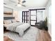 Relaxing bedroom with ceiling fan, closet, large windows, bathroom view, soft lighting, and modern decor creates a serene atmosphere at 4102 Stonehenge Rd, Mulberry, FL 33860