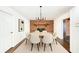 Cozy dining room with modern lighting fixture, hardwood floors, and fireplace at 4102 Stonehenge Rd, Mulberry, FL 33860
