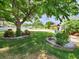 Charming front yard with lush lawn, mature trees, and decorative planters providing curb appeal at 4102 Stonehenge Rd, Mulberry, FL 33860