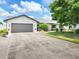 Charming single Gathering home featuring a spacious driveway and well manicured lawn and landscaping at 4102 Stonehenge Rd, Mulberry, FL 33860