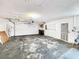 View of garage featuring an automatic door, a peg board for tool storage and easy access to the backyard at 4102 Stonehenge Rd, Mulberry, FL 33860