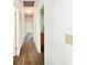 Hallway showcasing updated flooring, clean lines and neutral paint at 4102 Stonehenge Rd, Mulberry, FL 33860