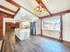 Open kitchen and living area with stainless steel appliances, an island and wood beams at 4102 Stonehenge Rd, Mulberry, FL 33860