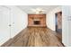Living room with decorative brick fireplace and hardwood floors at 4102 Stonehenge Rd, Mulberry, FL 33860
