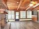 Spacious living room featuring a brick fireplace, wood floors and wood-beamed ceilings at 4102 Stonehenge Rd, Mulberry, FL 33860