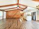 Open-concept living room featuring vaulted ceilings, wood beams, fireplace, and kitchen island at 4102 Stonehenge Rd, Mulberry, FL 33860