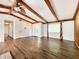 Open-concept living room boasts vaulted ceilings with wood beams and modern flooring at 4102 Stonehenge Rd, Mulberry, FL 33860