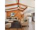 Bright living room with wood accents, vaulted ceilings and an open floor plan leading to the modern kitchen at 4102 Stonehenge Rd, Mulberry, FL 33860