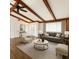 Bright living room with hardwood floors, wood beams, and lots of natural light at 4102 Stonehenge Rd, Mulberry, FL 33860
