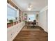 Well-lit office features built-in bookshelves, a window for natural light, hardwood floors, and is equipped with a modern desk at 4102 Stonehenge Rd, Mulberry, FL 33860
