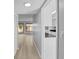 Hallway with wood flooring and access to a well-lit kitchen area at 4160 Player Cir # 109, Orlando, FL 32808