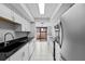 Spacious kitchen with sleek black countertops and modern stainless steel appliances at 4160 Player Cir # 109, Orlando, FL 32808