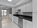 Modern kitchen showcasing stainless steel appliances, dark countertops, and white cabinetry at 4160 Player Cir # 109, Orlando, FL 32808