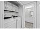 Convenient laundry space with modern washer and dryer, adjacent to a well-appointed bathroom with elegant flooring at 4160 Player Cir # 109, Orlando, FL 32808
