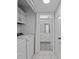 Functional laundry area with modern machines, cabinets, and access to a stylish bathroom, offering convenience and style at 4160 Player Cir # 109, Orlando, FL 32808