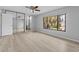 Main bedroom featuring mirrored closet doors, modern flooring, and a bright window with a peek to the en suite bathroom at 4160 Player Cir # 109, Orlando, FL 32808