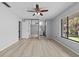 Bright main bedroom with light-colored floors, ceiling fan, sliding door mirrored closet, and large window at 4160 Player Cir # 109, Orlando, FL 32808