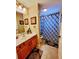 Bathroom featuring a single sink vanity with a decorative shower curtain and matching rug at 4471 Marsh Harbor Dr, Tavares, FL 32778