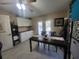 Bonus room with a table, storage cabinets, tile flooring, and doors leading to the outside at 4471 Marsh Harbor Dr, Tavares, FL 32778