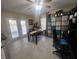 Bonus room featuring a table with seating, tile flooring, and shelving for storage and decor at 4471 Marsh Harbor Dr, Tavares, FL 32778