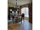 Cozy dining area with tile flooring, chandelier lighting and a large window at 4471 Marsh Harbor Dr, Tavares, FL 32778