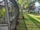 View of the screened-in patio from the yard and showing garden area at 4471 Marsh Harbor Dr, Tavares, FL 32778