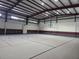 Vast indoor gymnasium with basketball court, high ceilings, and side seating area for versatile activities at 4471 Marsh Harbor Dr, Tavares, FL 32778