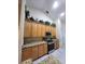 Well-equipped kitchen with wooden cabinets, granite countertops, and modern stainless steel appliances at 4471 Marsh Harbor Dr, Tavares, FL 32778