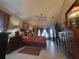 Serene main bedroom with hardwood furniture, a comfy bed, and natural light from the large windows at 4471 Marsh Harbor Dr, Tavares, FL 32778