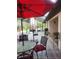 Screened patio featuring tile flooring, comfortable seating, outdoor grill and large umbrellas at 4471 Marsh Harbor Dr, Tavares, FL 32778