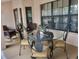 Patio area with seating around a glass-topped table with decorative pineapple-themed chairs at 4471 Marsh Harbor Dr, Tavares, FL 32778