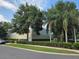 Exterior shot of the community recreation center with mature trees and manicured landscaping on a partly cloudy day at 4471 Marsh Harbor Dr, Tavares, FL 32778