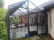 Enclosed patio featuring tiled floor, dining area with seating, and access to the yard at 4471 Marsh Harbor Dr, Tavares, FL 32778