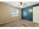 This bedroom features a ceiling fan, window, and neutral paint colors at 6125 Morningdale Ave, Lakeland, FL 33813