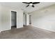 This bedroom features carpet floors, a ceiling fan, and an attached walk-in closet at 6125 Morningdale Ave, Lakeland, FL 33813