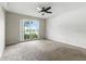 Bedroom with a large window and plush carpet, providing ample natural light at 6125 Morningdale Ave, Lakeland, FL 33813